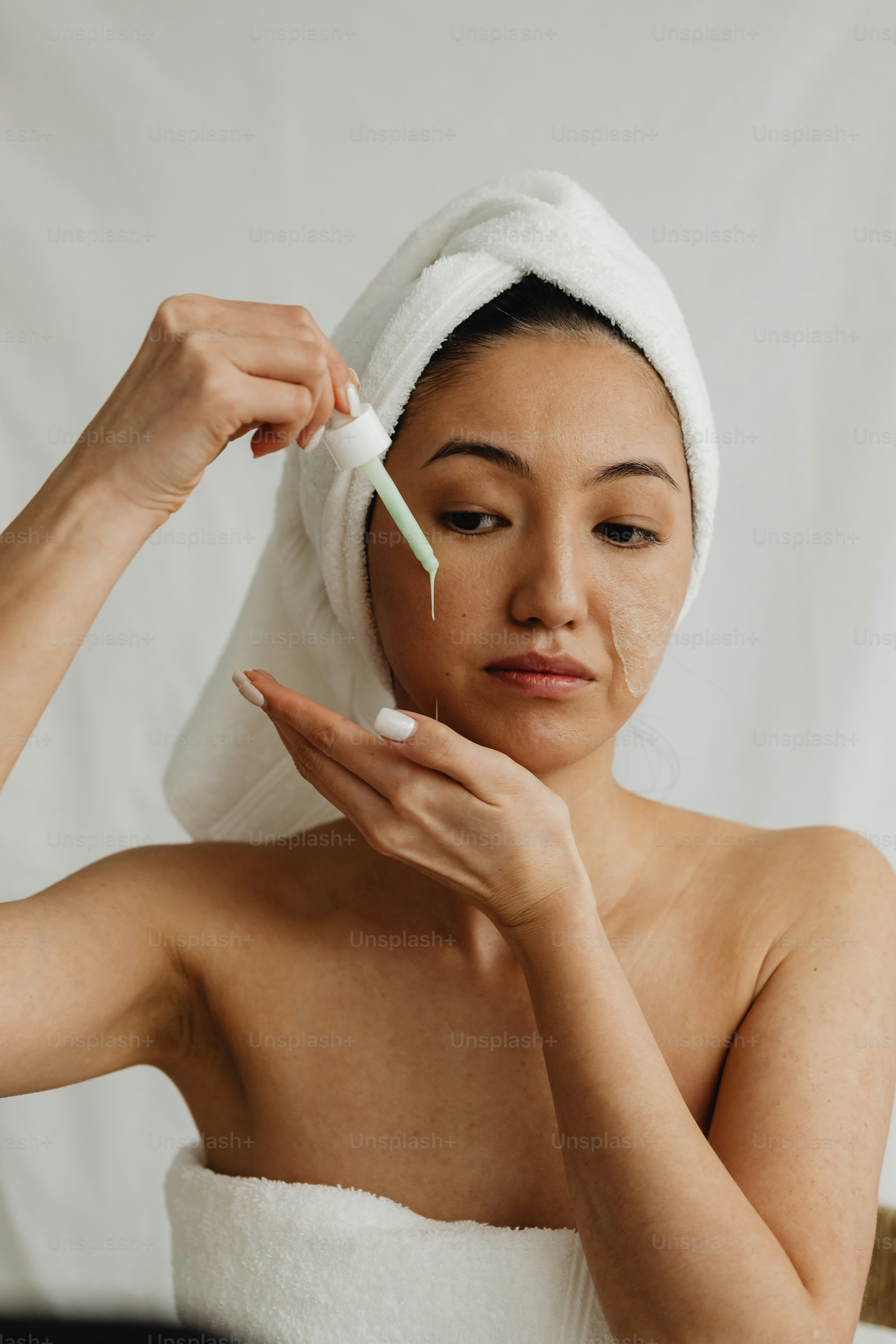 a woman with a towel on her head and a toothbrush in her hand