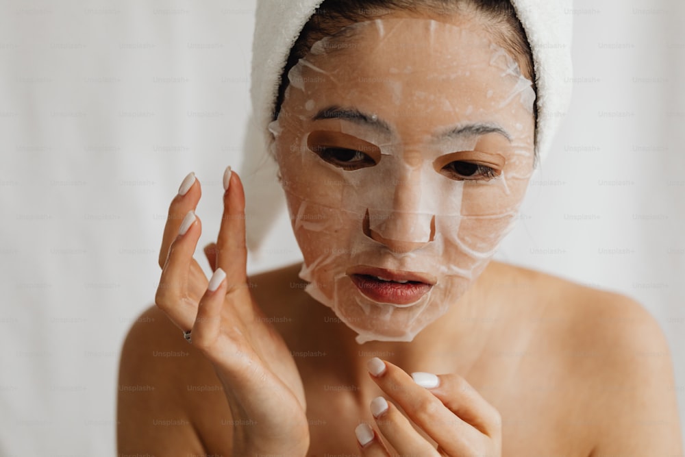 a woman with a towel on her head and a mask on her face