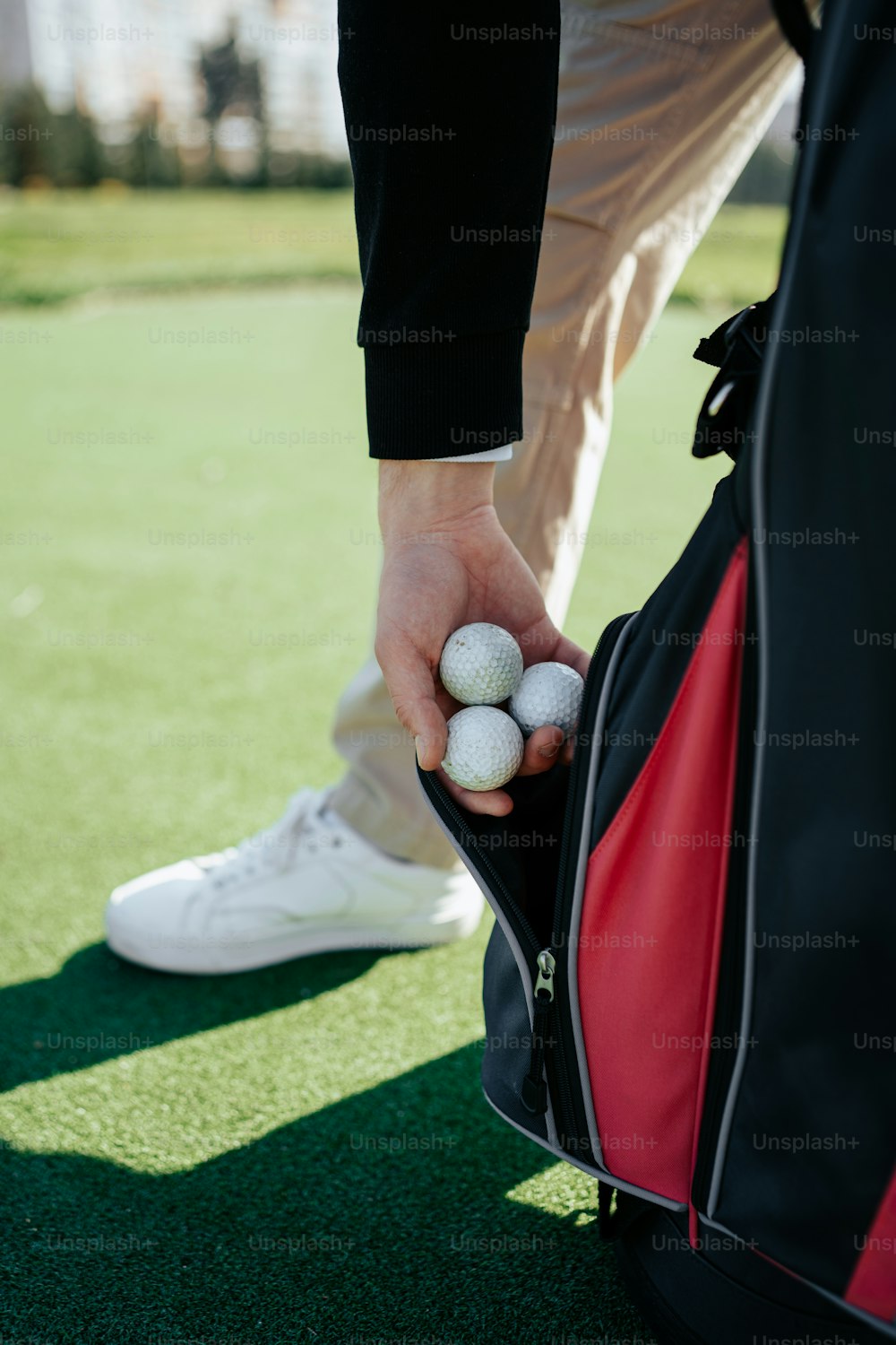 a person holding a golf ball in a bag