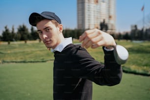 a man holding a golf club in his right hand