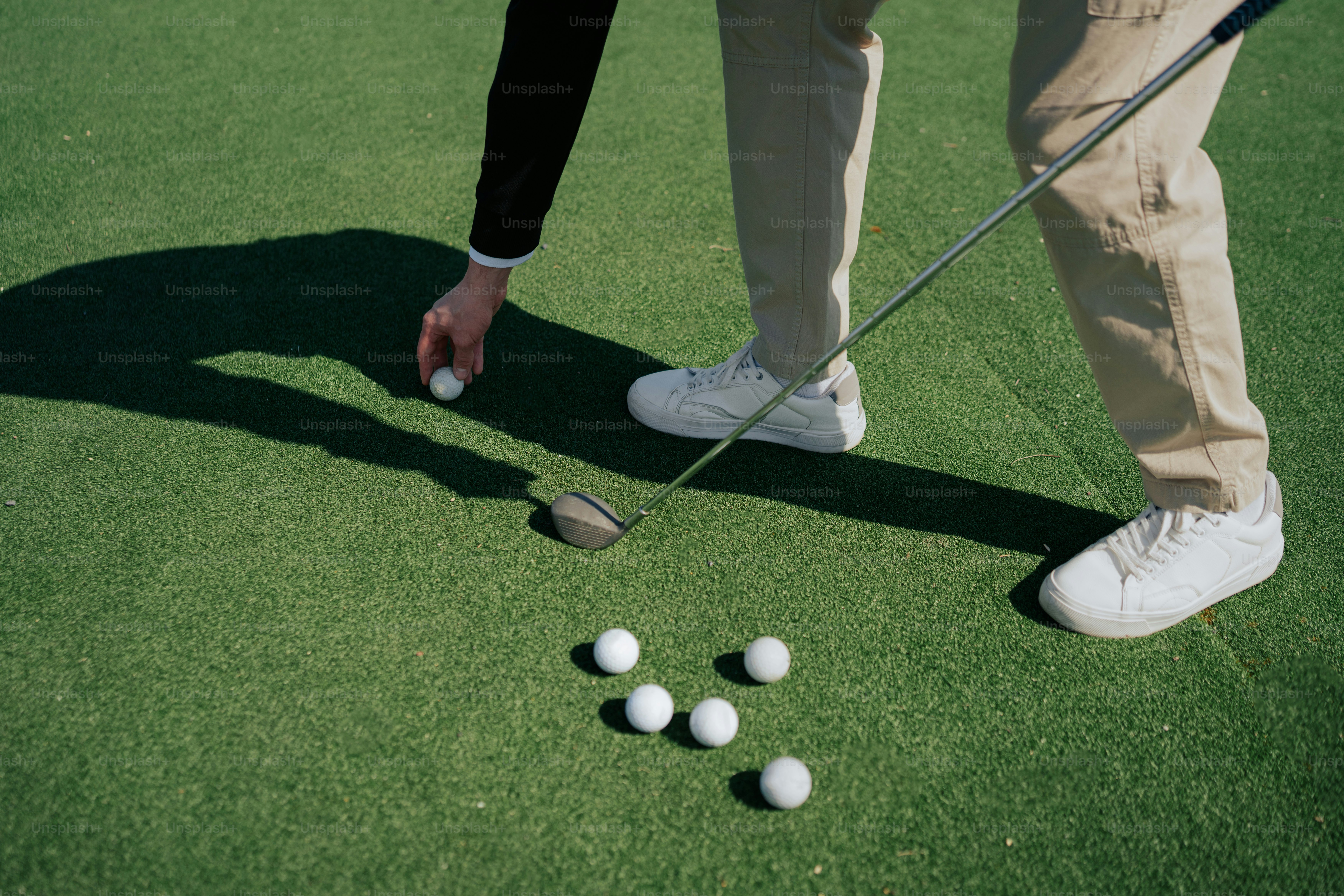 a man putting golf balls on a putting green