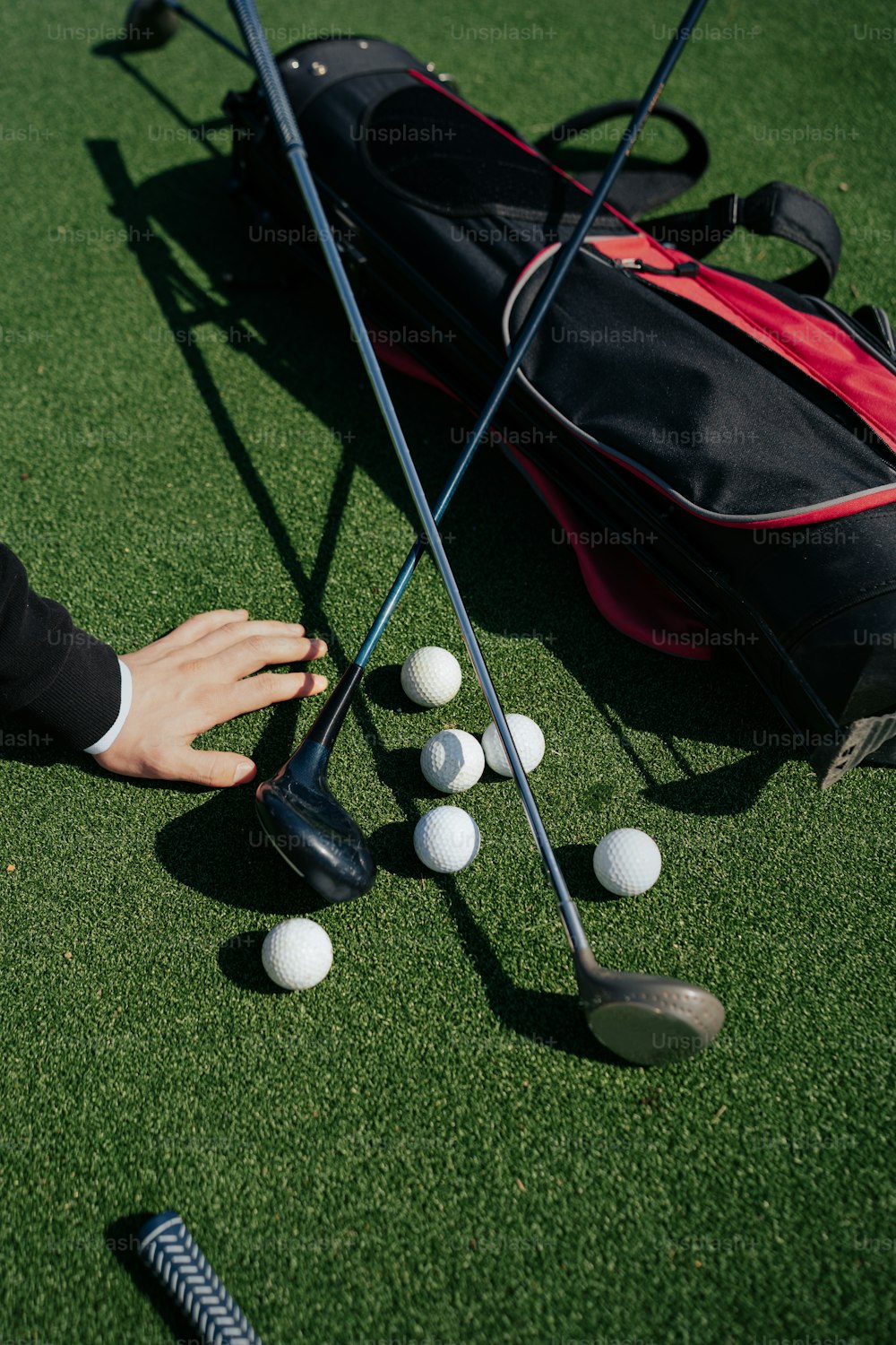 a person putting golf balls in a golf bag