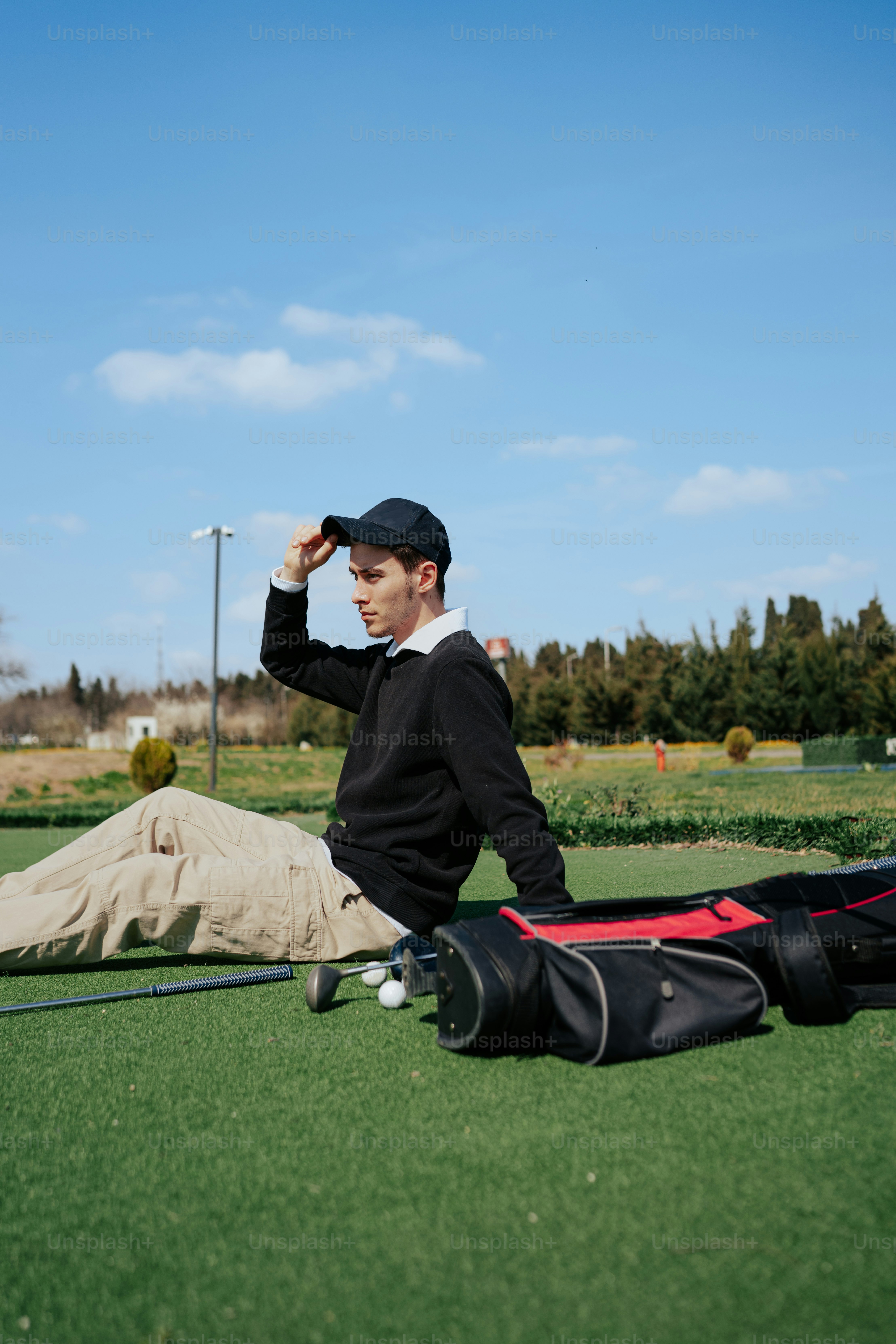 a man sitting on the ground with a baseball bat