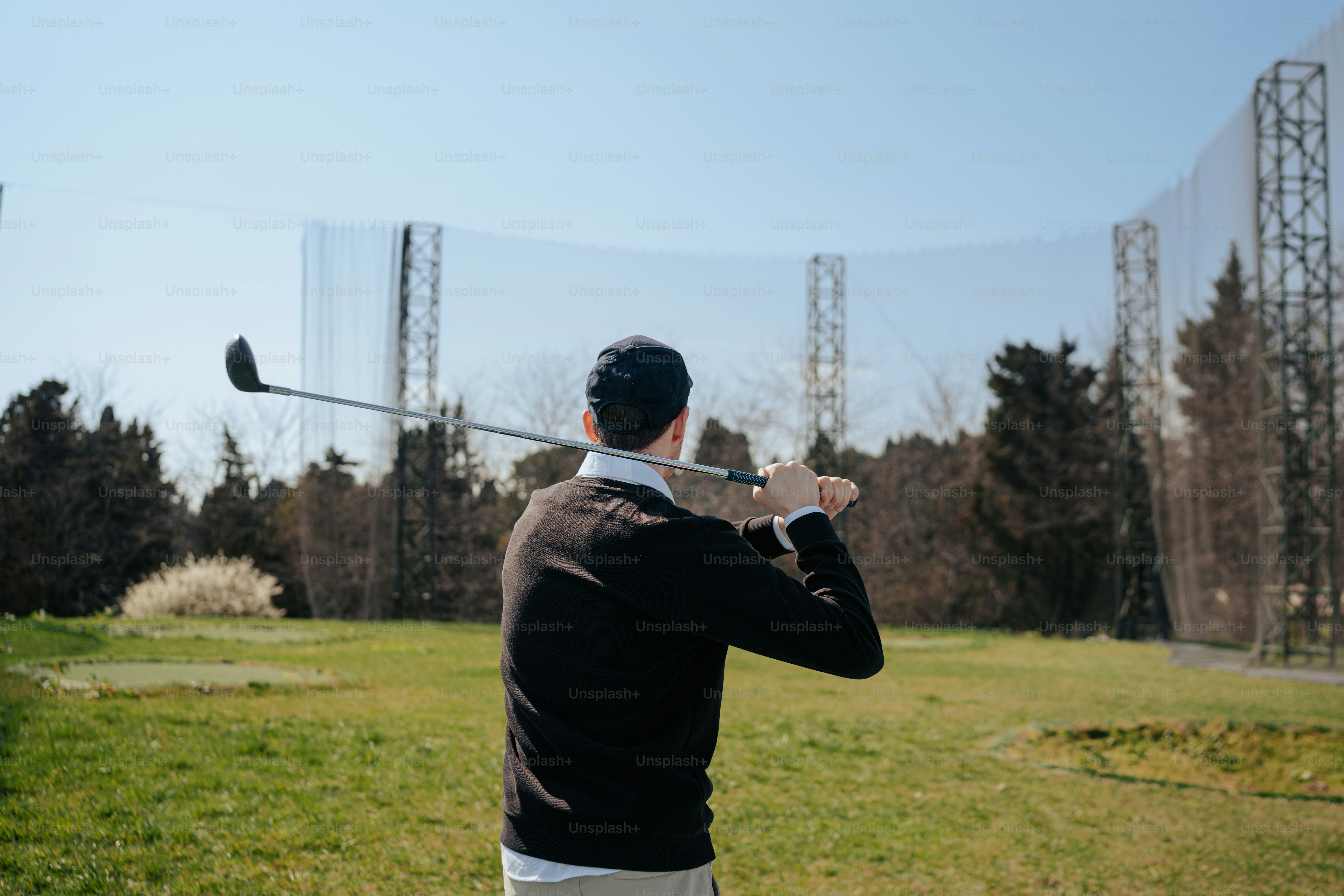 a man in a suit swinging a golf club