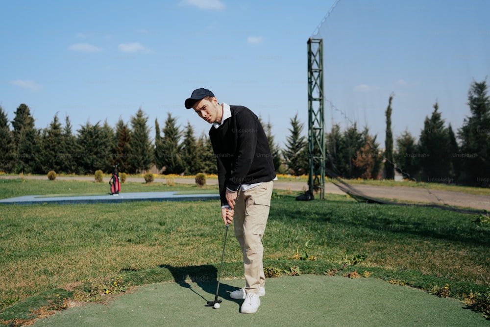 a man standing on top of a green field