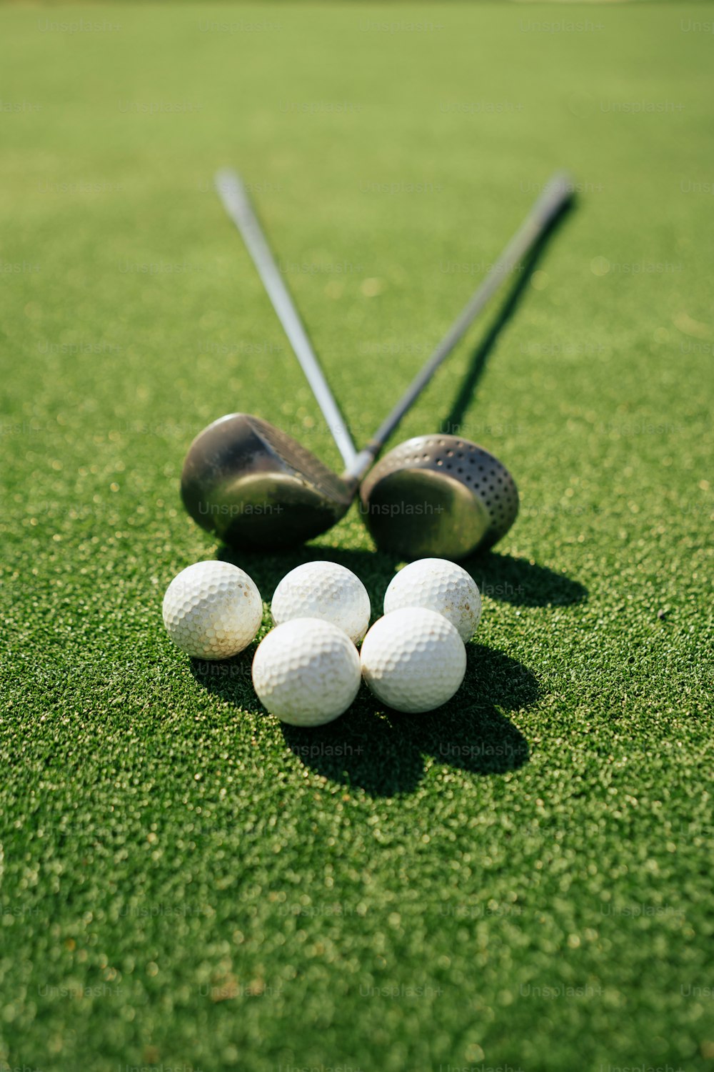 a group of golf balls sitting on top of a green field