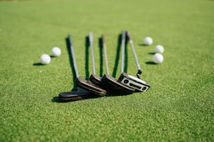 a group of golf clubs sitting on top of a green field