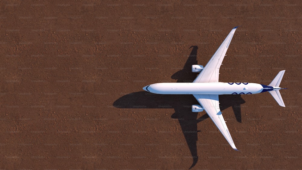 a white airplane flying over a brown ground