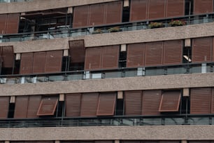 a tall building with lots of windows and wooden shutters