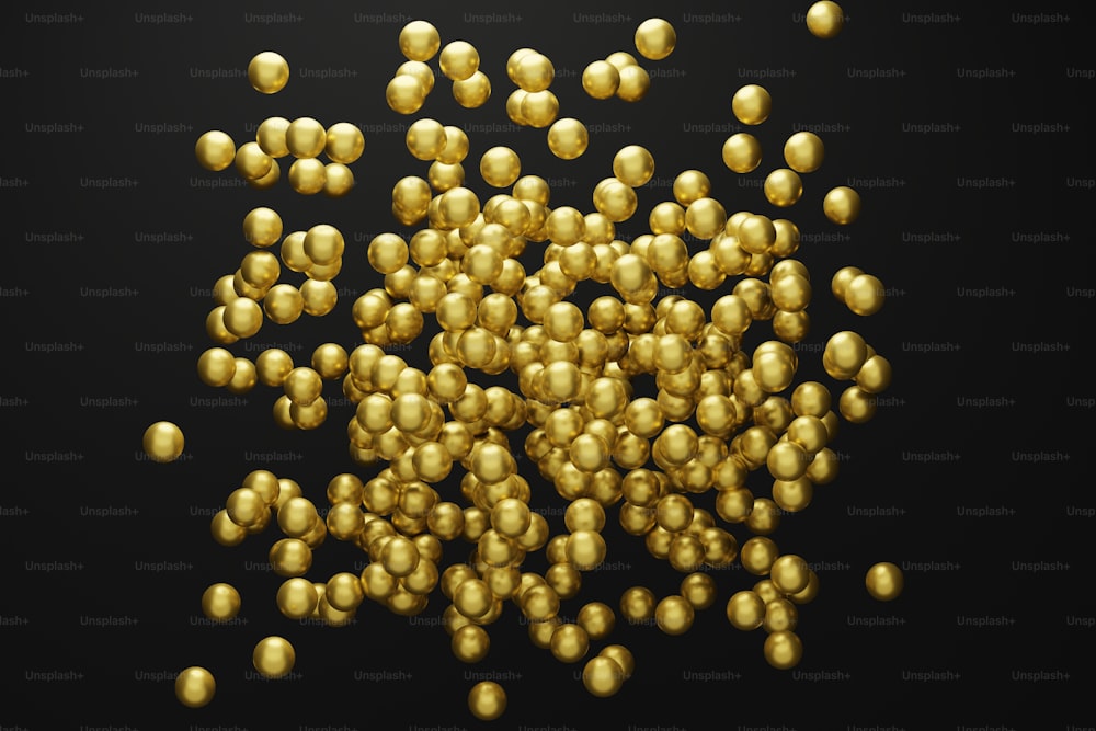 a pile of gold balls on a black background