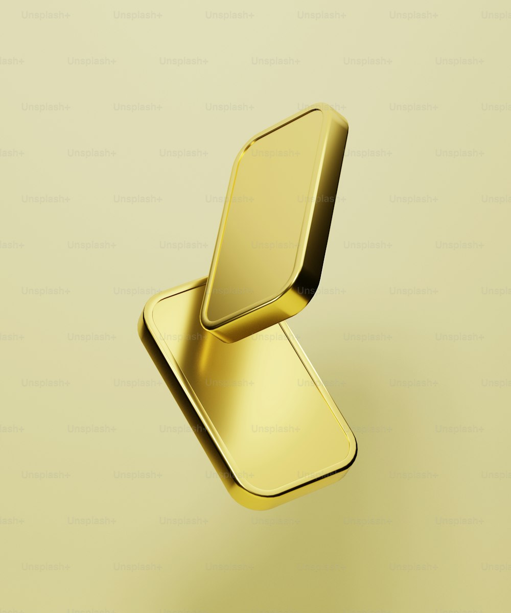 a gold metal object on a yellow background