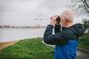a man looking through a pair of binoculars