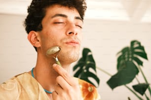 a man is brushing his teeth with a brush