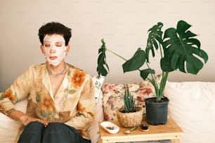 a woman sitting on a couch with a face mask on