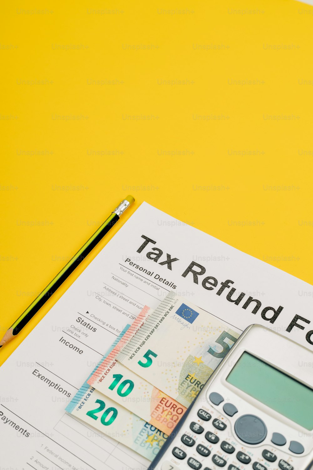 a calculator sitting on top of a tax refund form