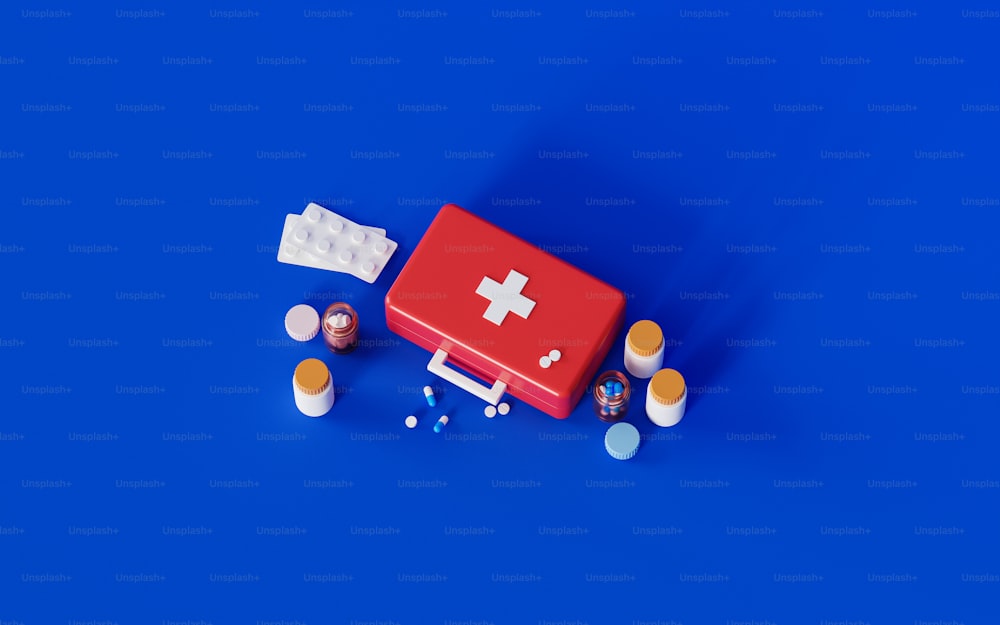 a red first aid kit sitting on top of a blue surface