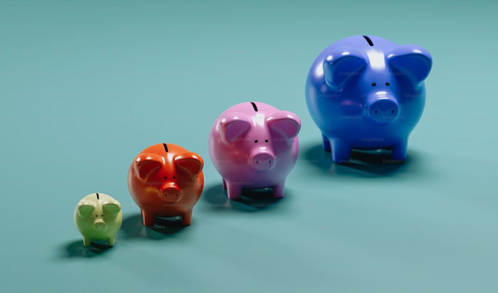 three colorful piggy banks sitting next to each other