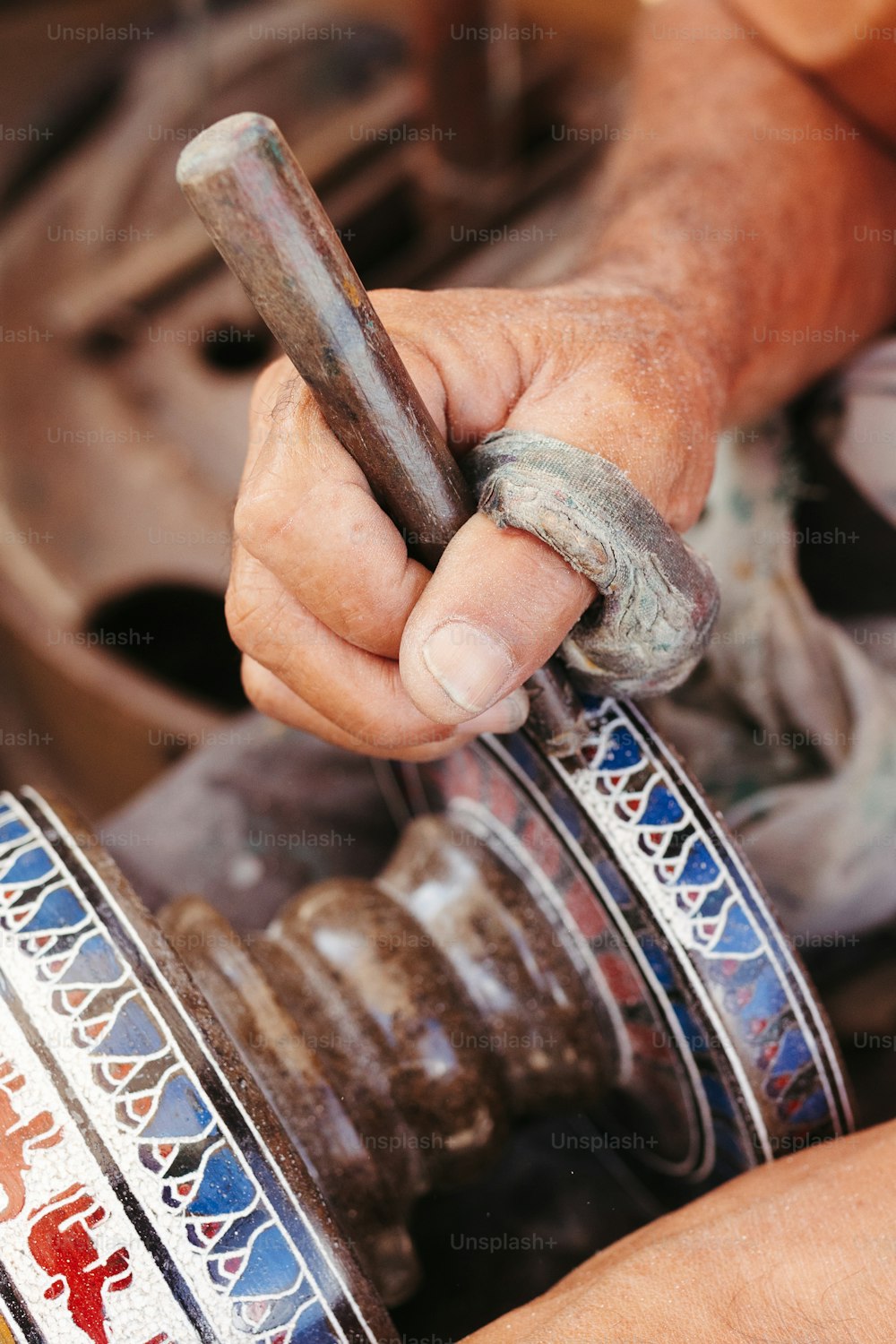 a man is holding a wrench in his hand