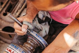a man working on a piece of metal