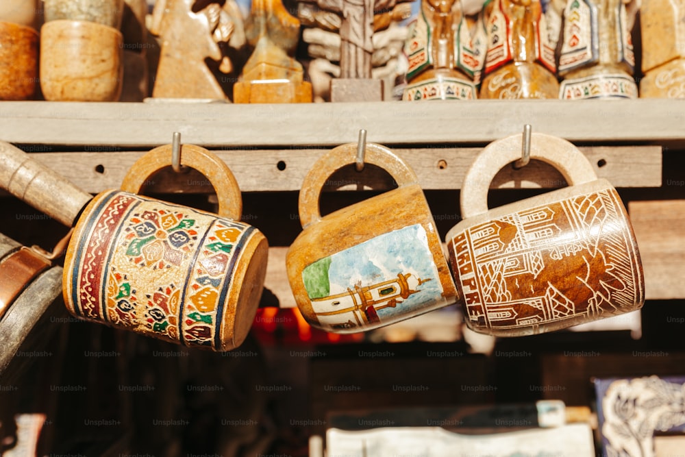 a bunch of pots are hanging on a rack