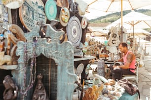 a man sitting on a chair in front of a store