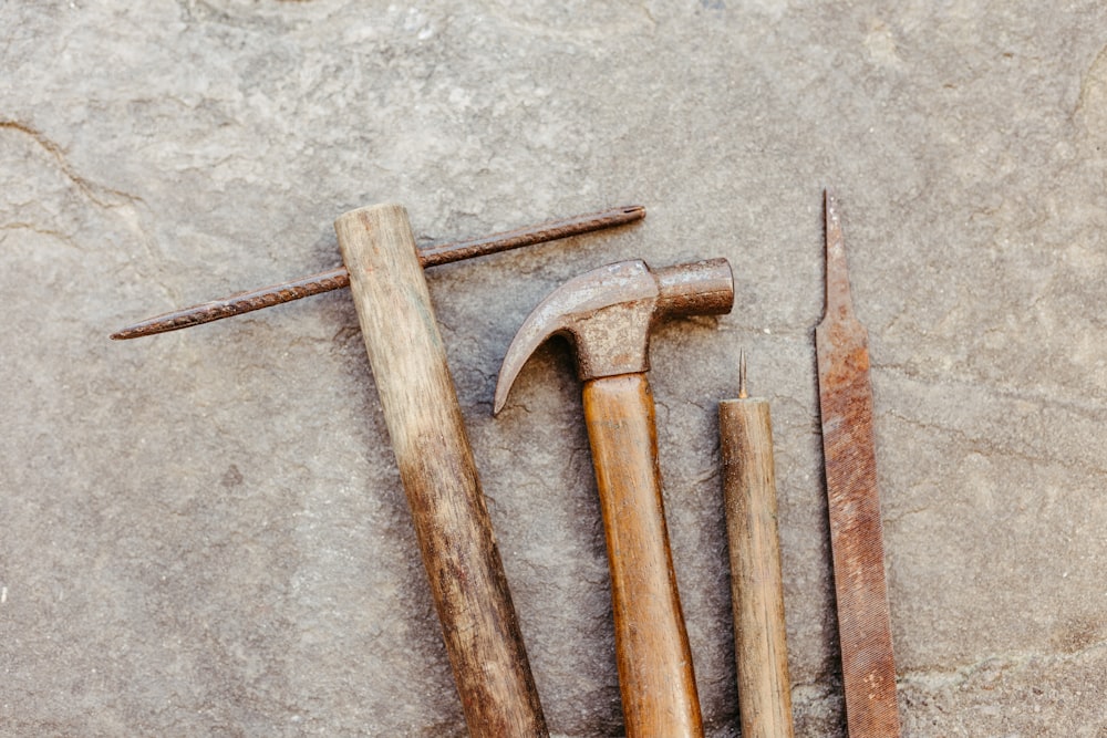 a hammer, a wrench, and a hammer on a stone surface