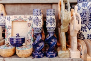 a table topped with lots of blue and white vases