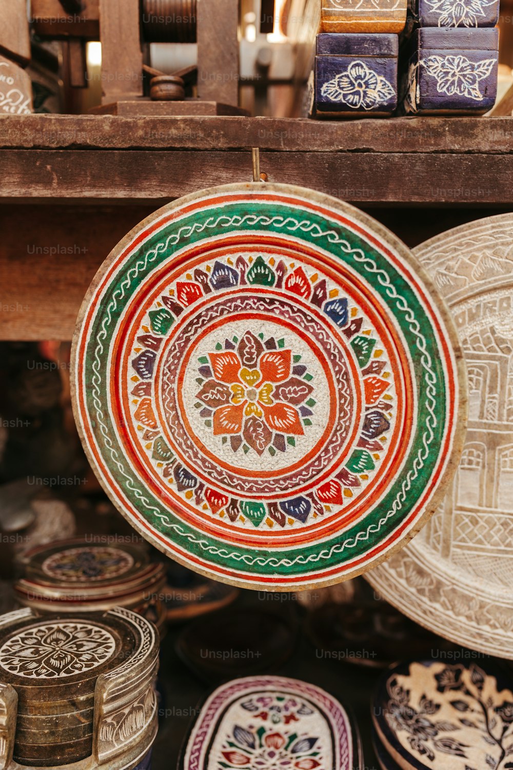 a colorful plate is hanging on a shelf