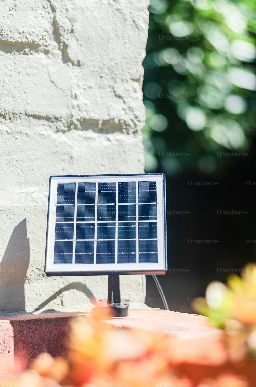 a solar panel on top of a brick wall