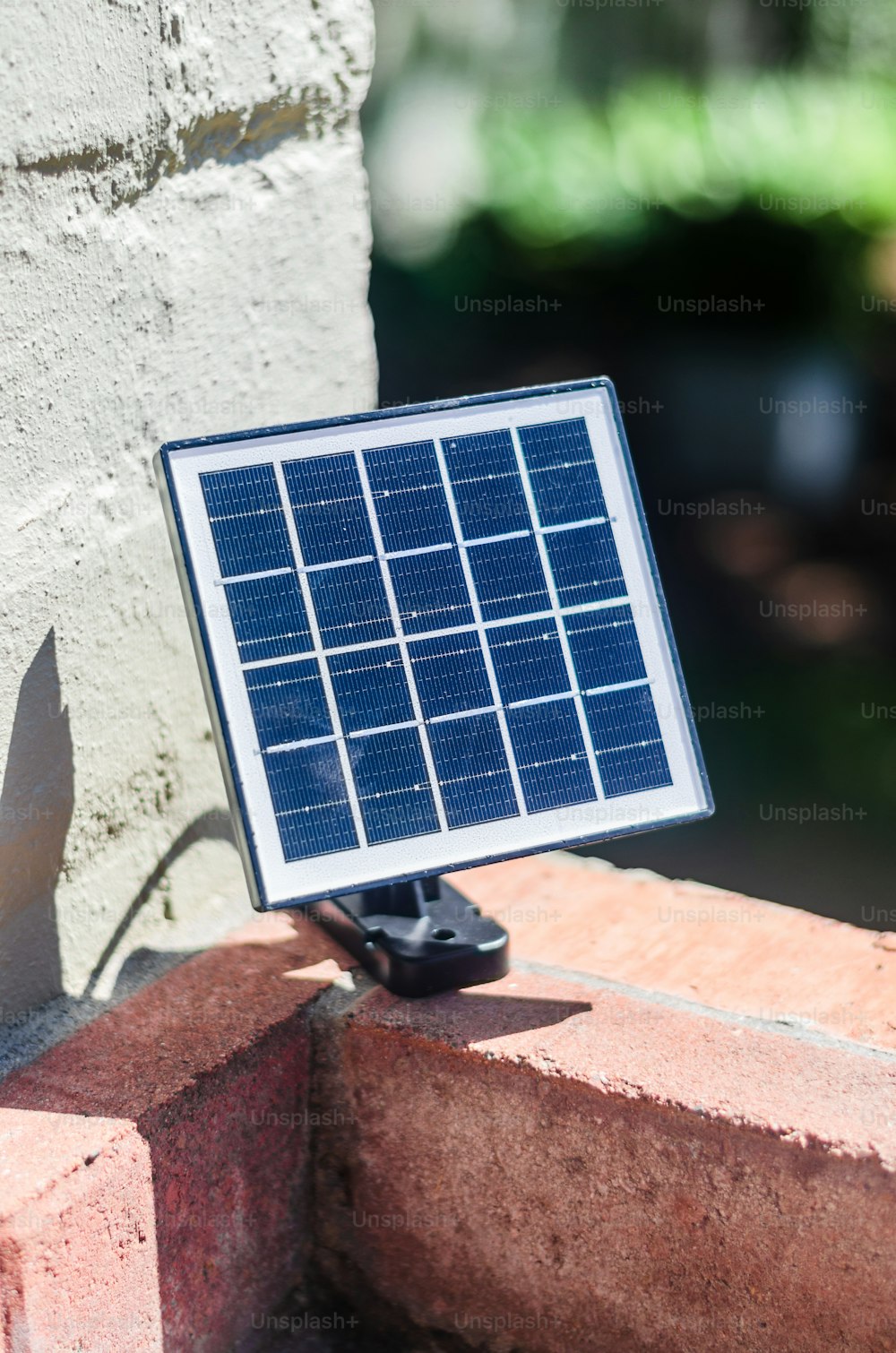 a solar panel attached to a brick wall