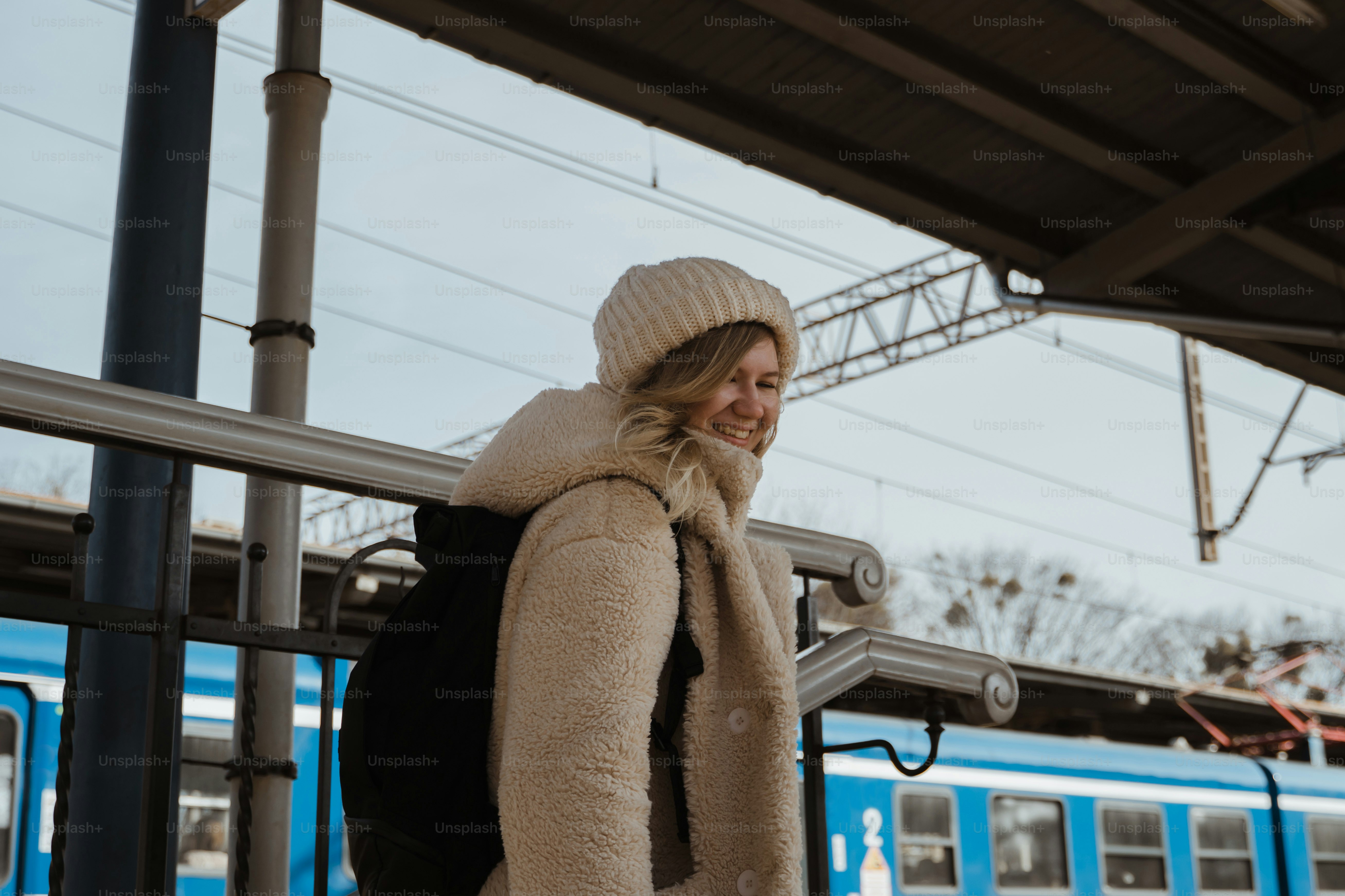 Female traveller at the train station, exploring Europe by train