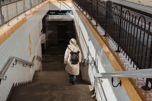 a woman walking down a flight of stairs