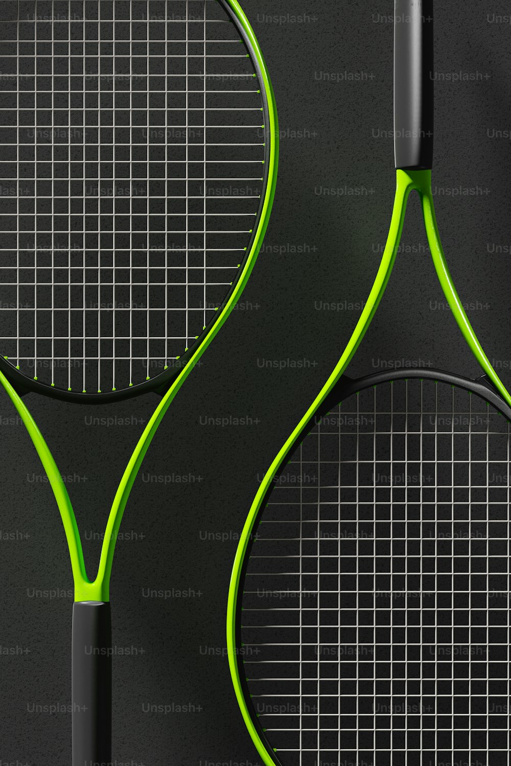two tennis racquets on a black surface