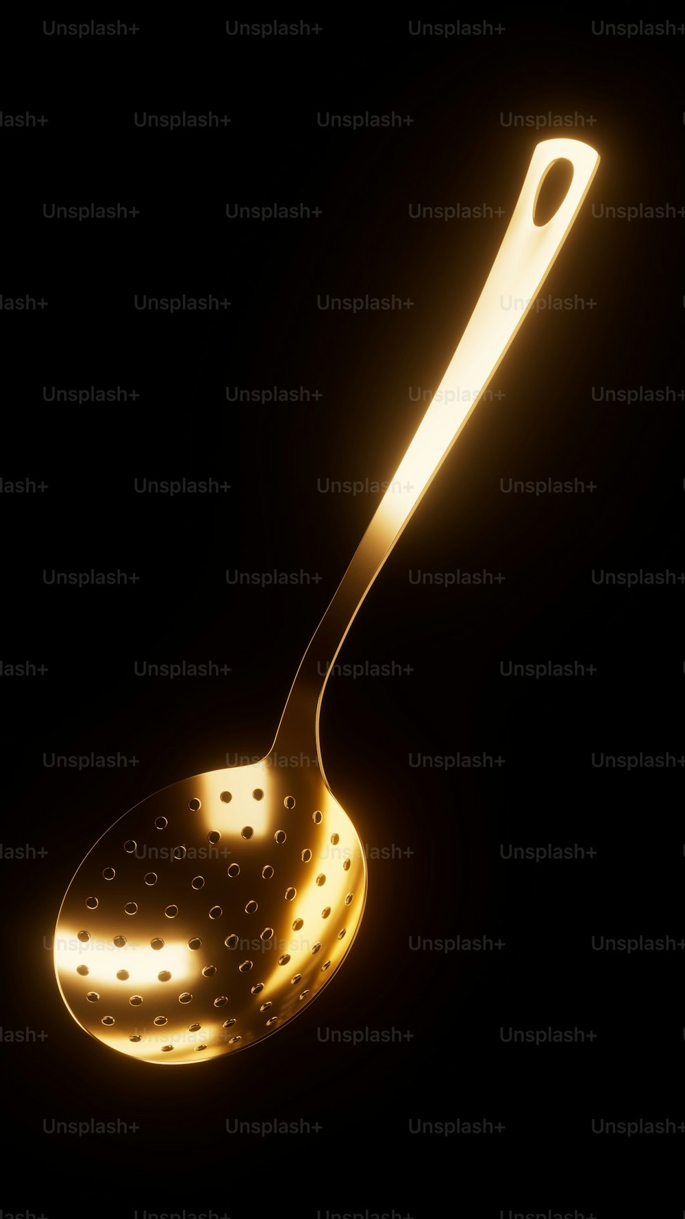 a yellow light shines on a metal spoon