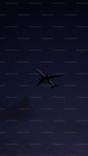 an airplane is flying in the sky at night