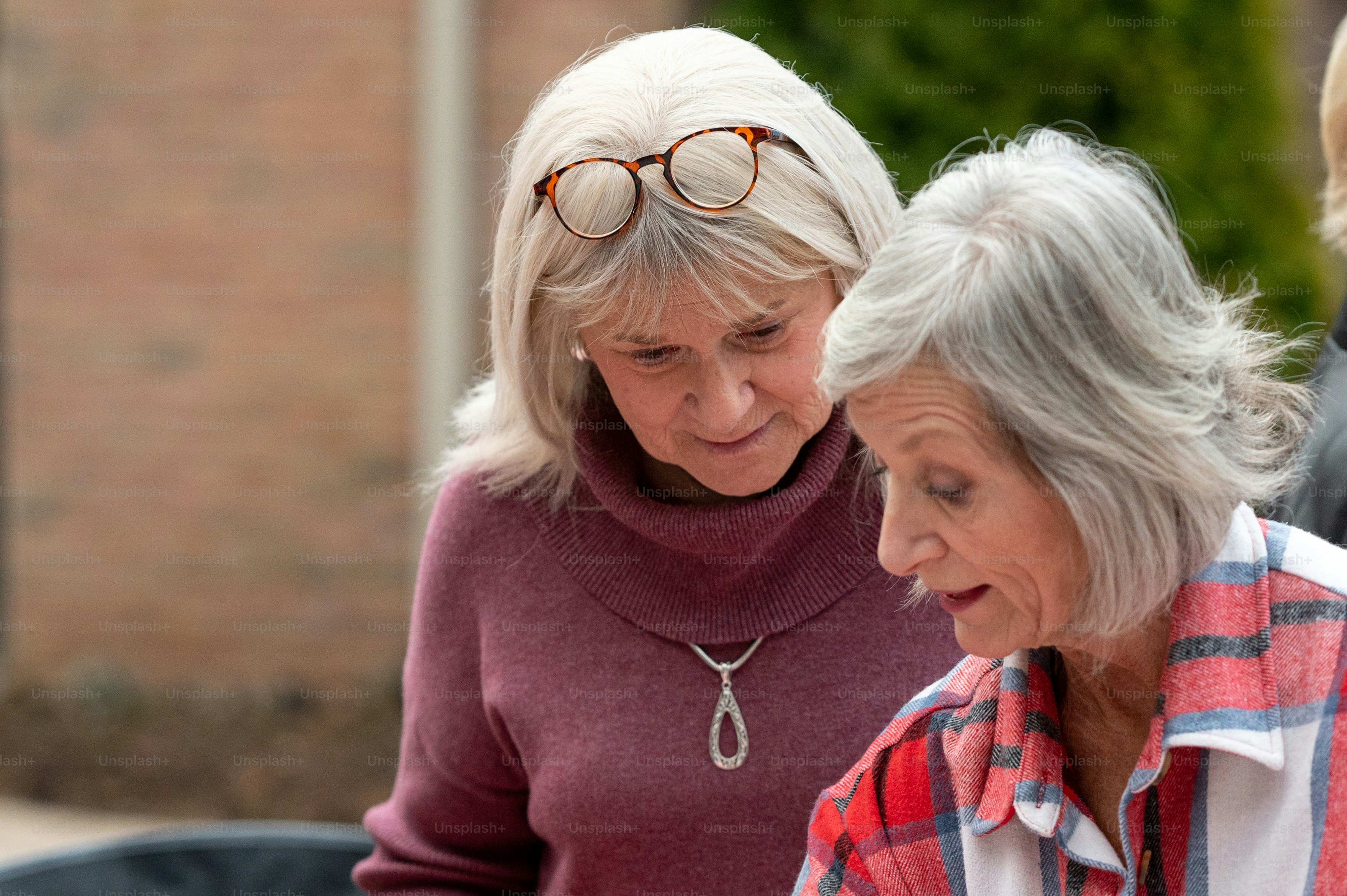 two older women looking at a cell phone