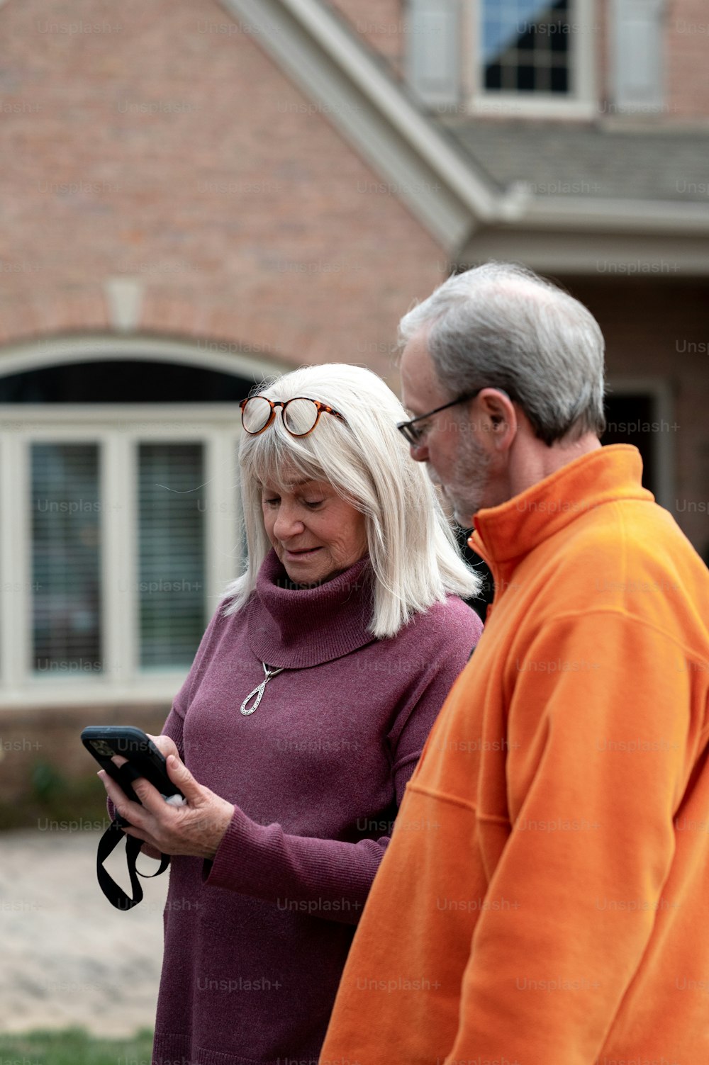 a man and a woman looking at a cell phone