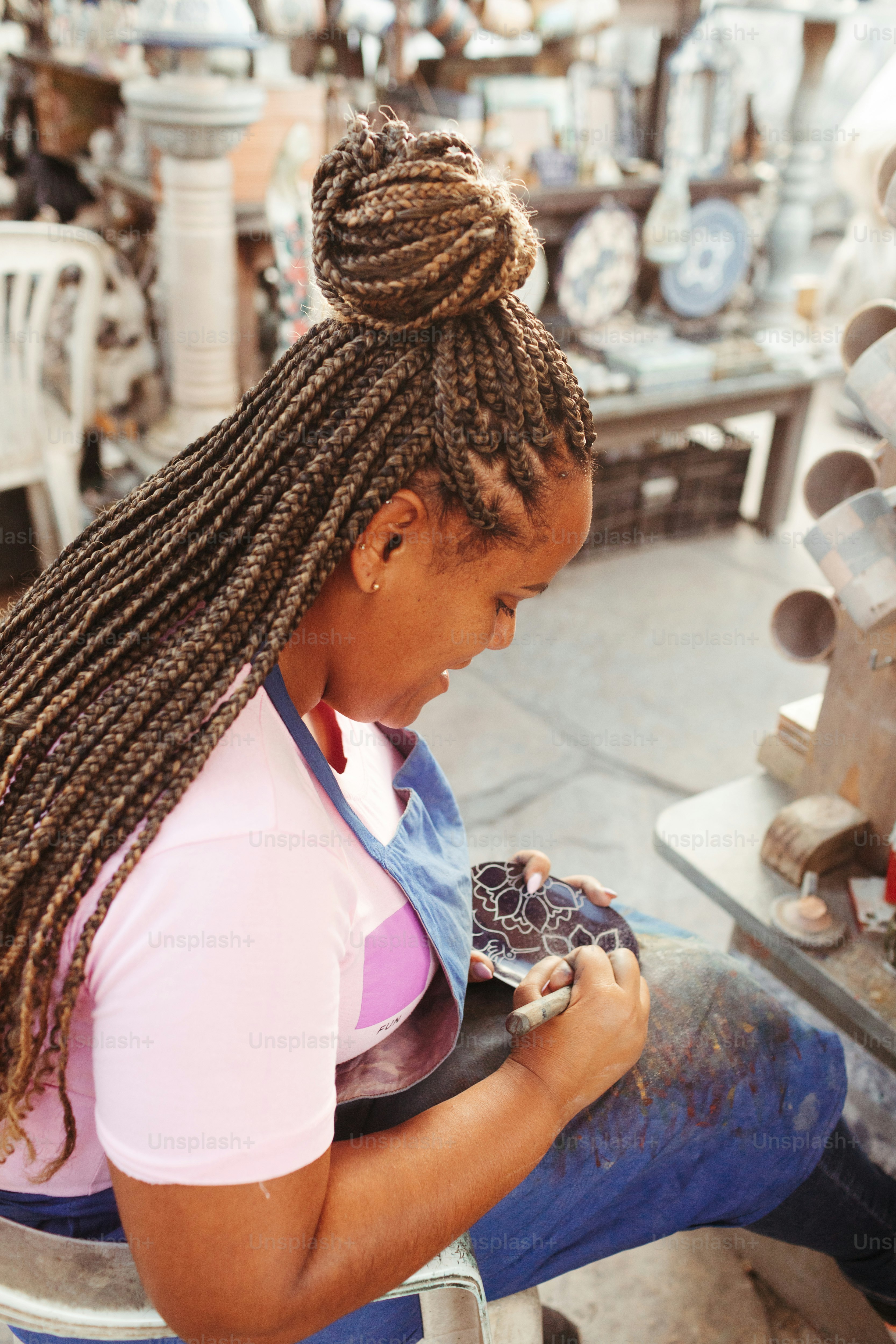 a woman sitting in a chair looking at a cell phone