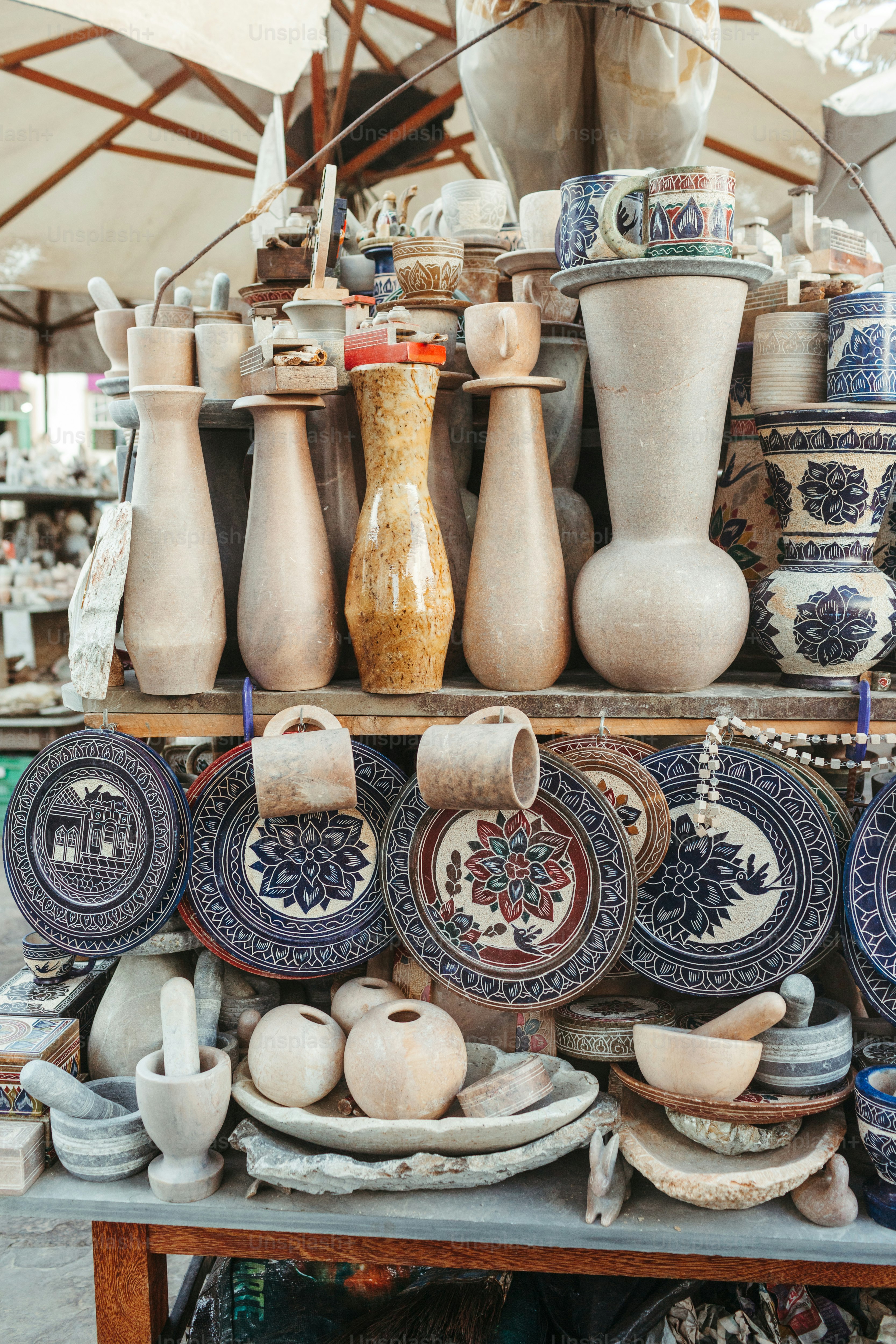 a table topped with lots of plates and vases