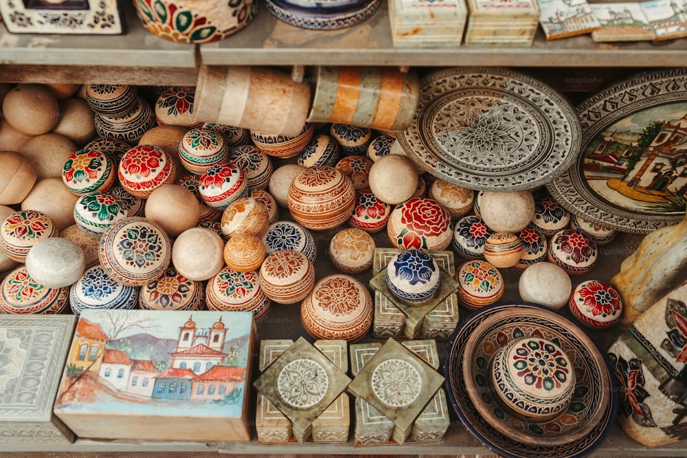 a shelf filled with lots of different types of pottery