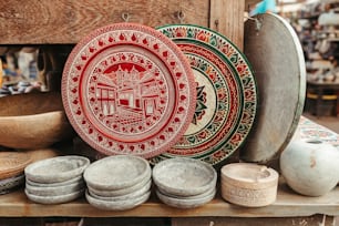 a table topped with plates and bowls on top of a wooden table