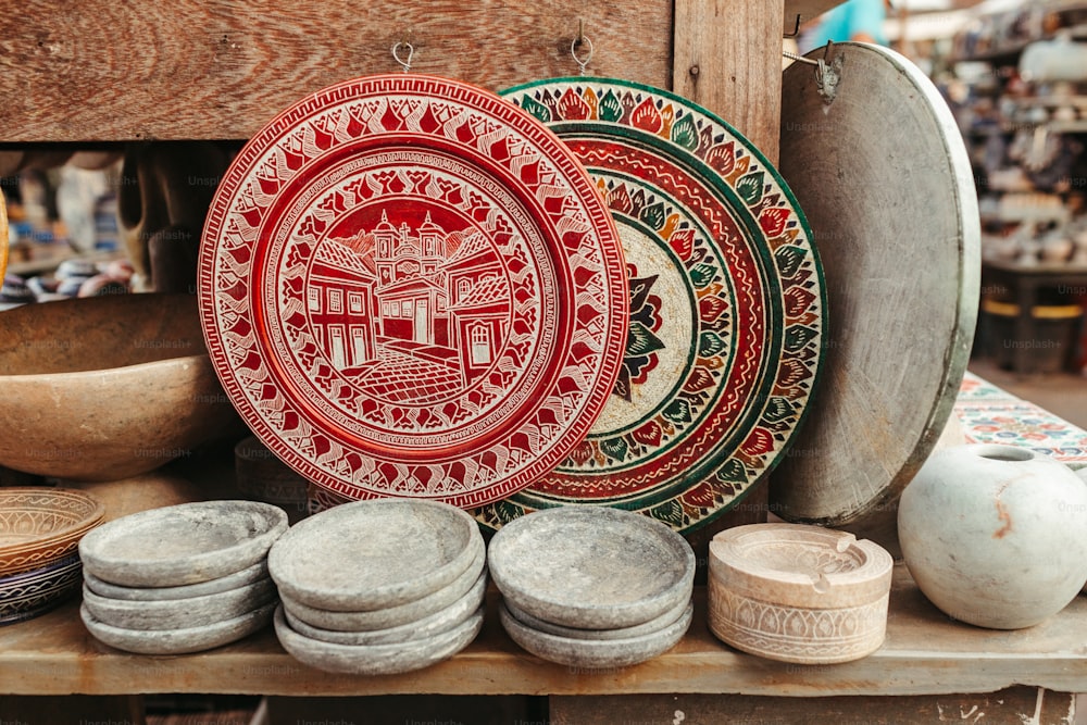 a table topped with plates and bowls on top of a wooden table