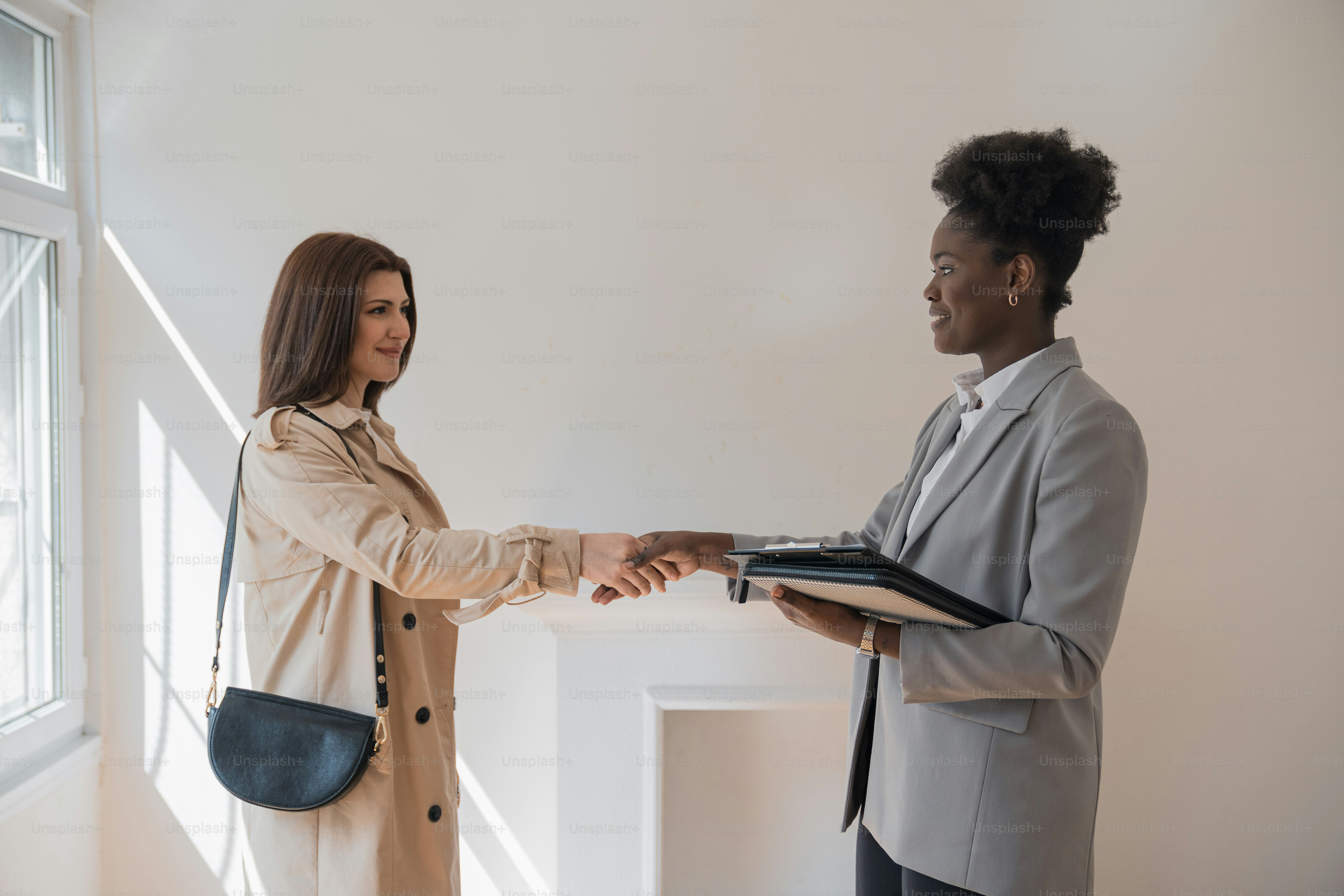 a woman shaking hands with a man in a suit