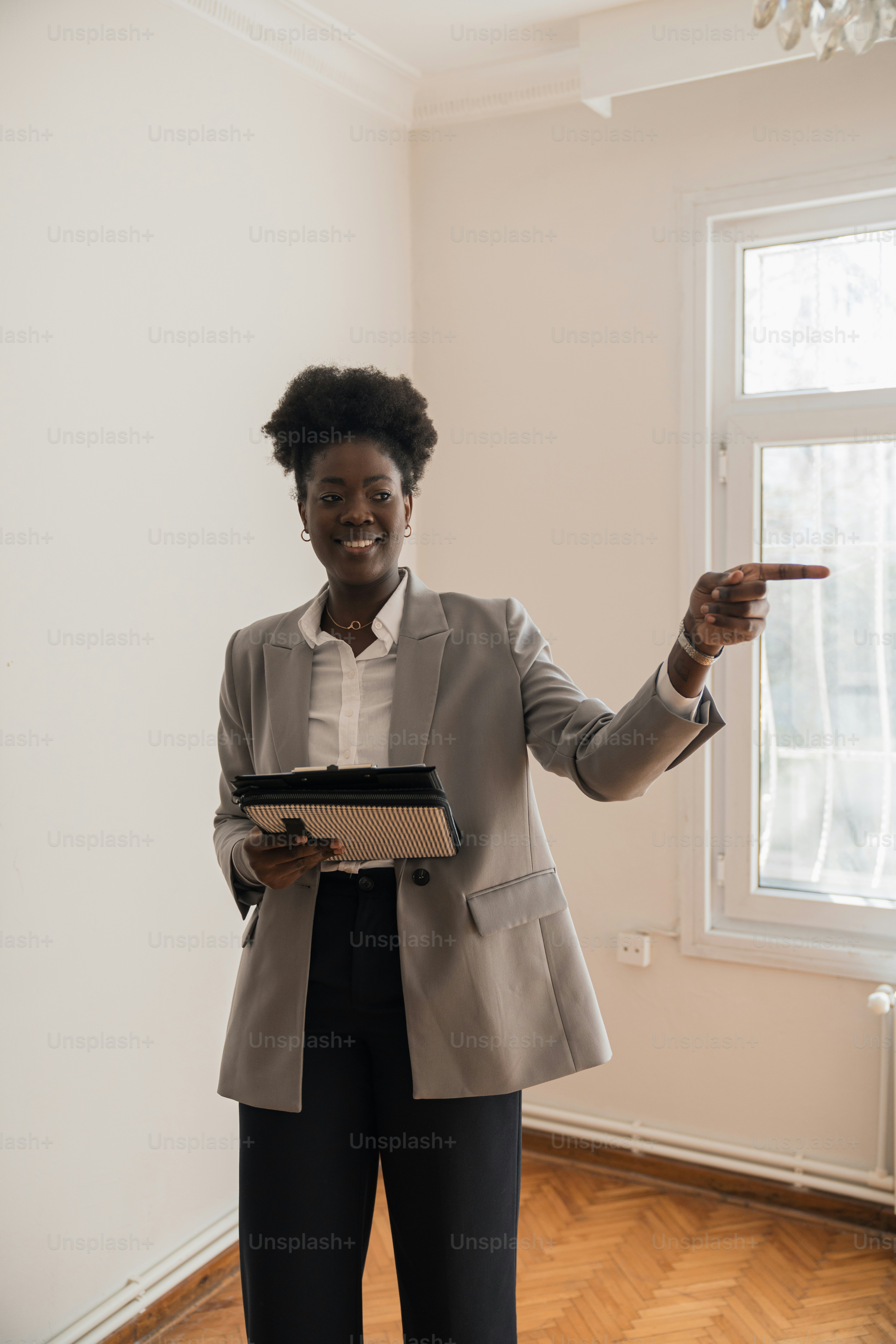 a woman in a business suit pointing at something