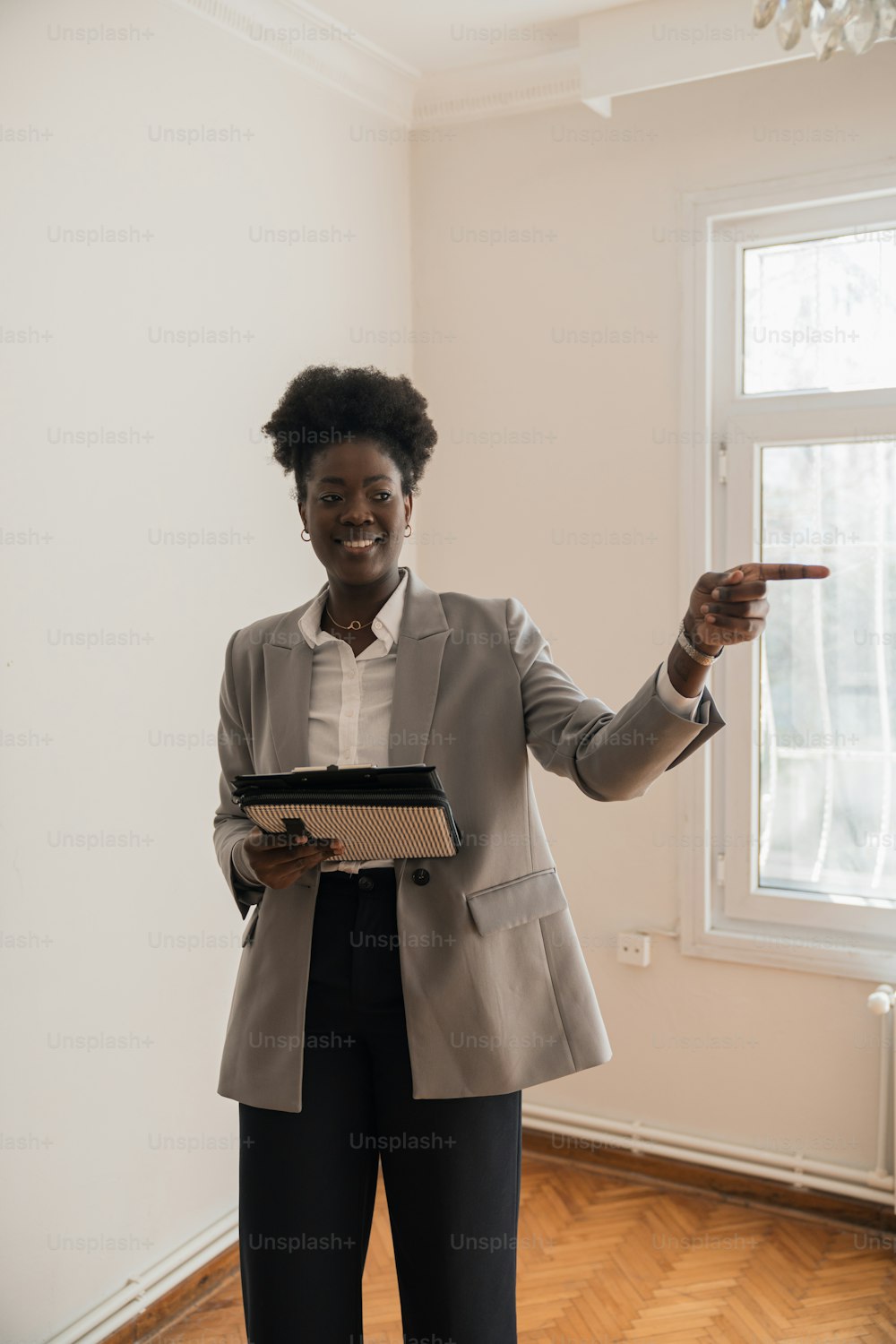 a woman in a business suit pointing at something