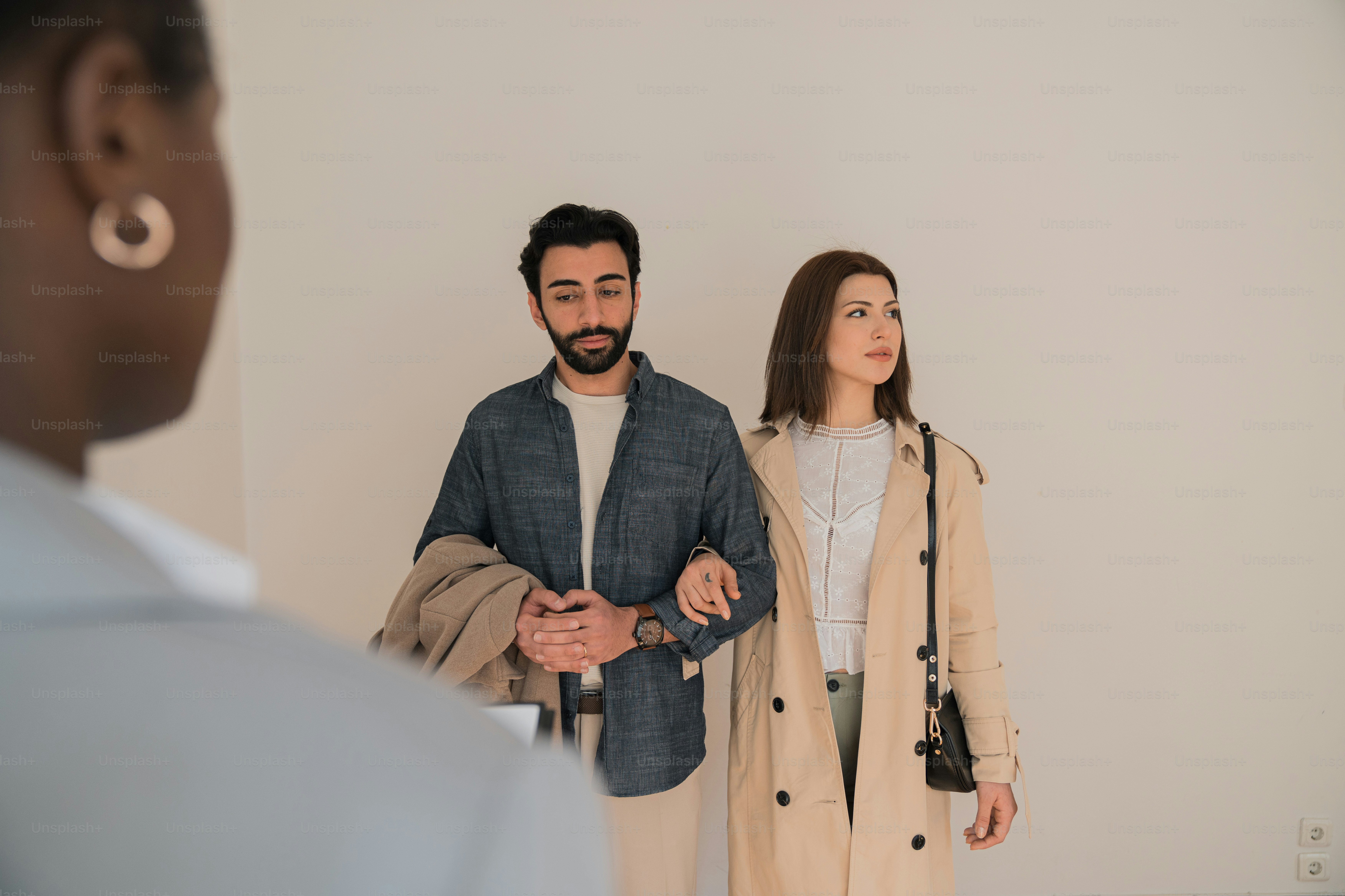 a man standing next to a woman in a room