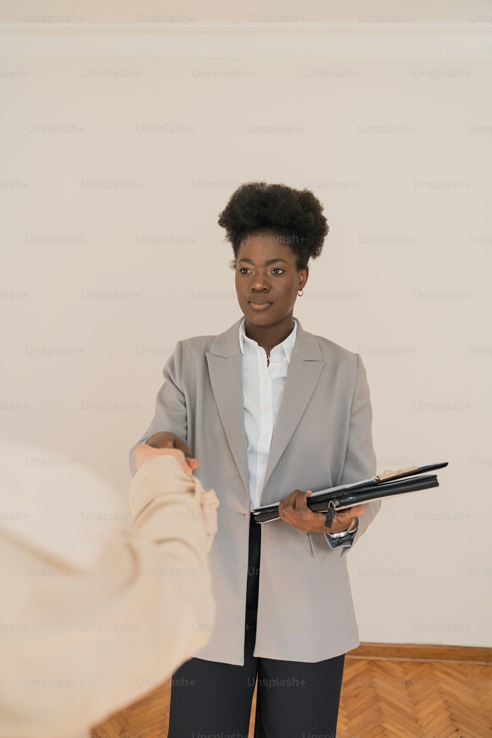 a woman in a business suit holding a clipboard