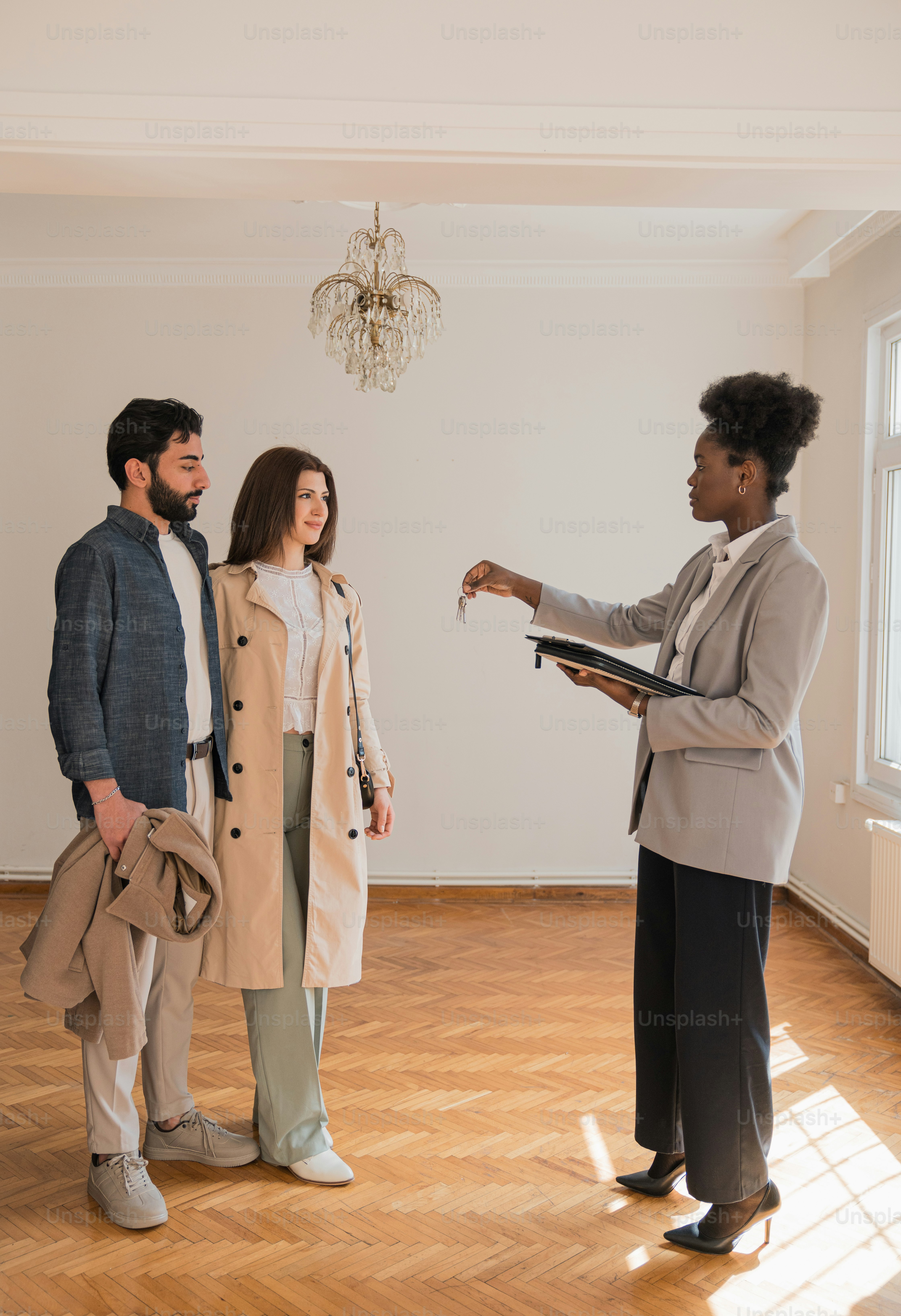 a man and two women standing in a room