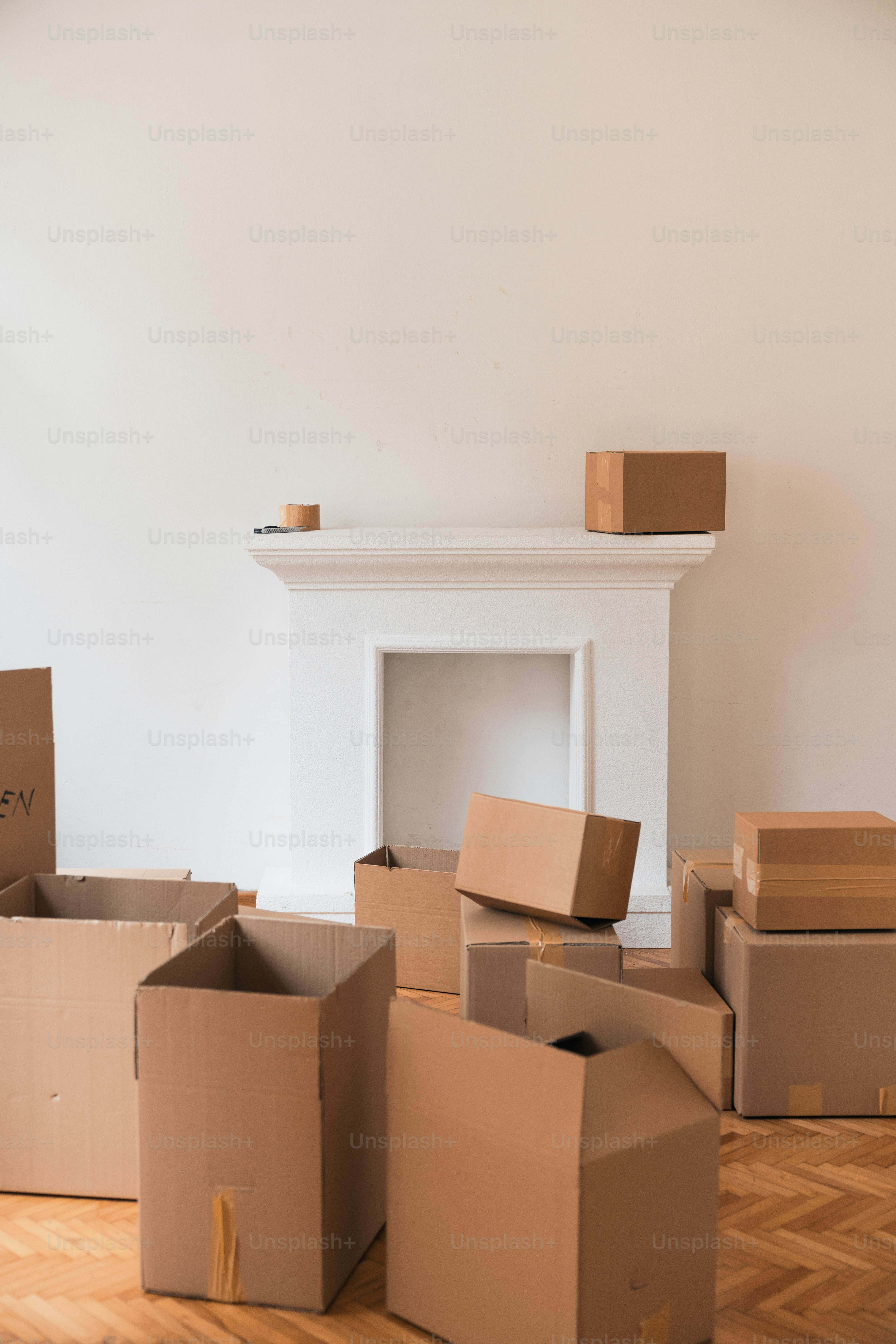 a pile of cardboard boxes sitting on top of a hard wood floor