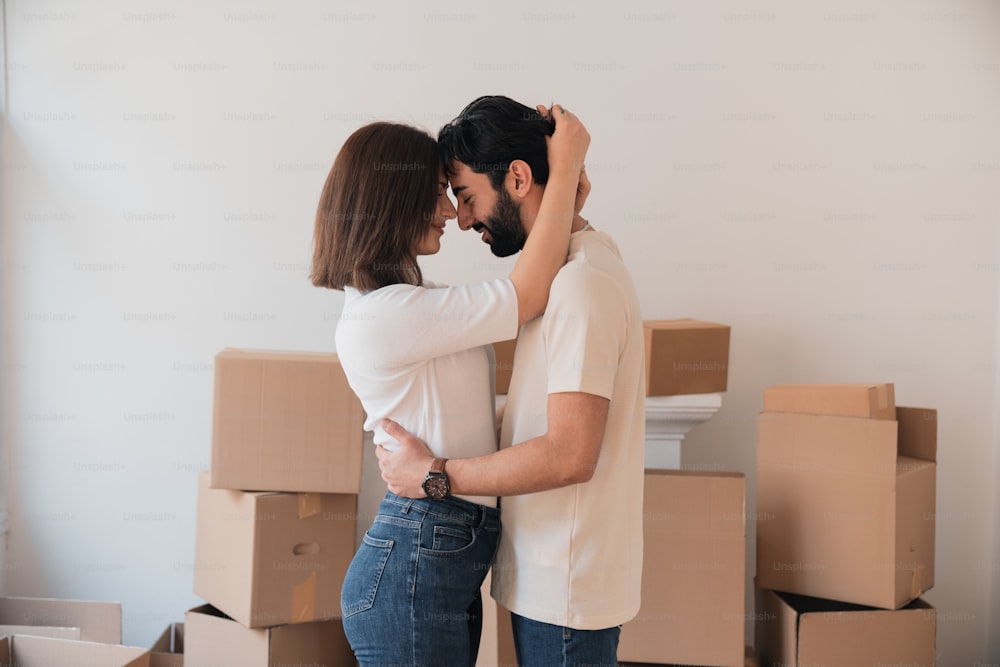 a man and woman embracing in front of boxes